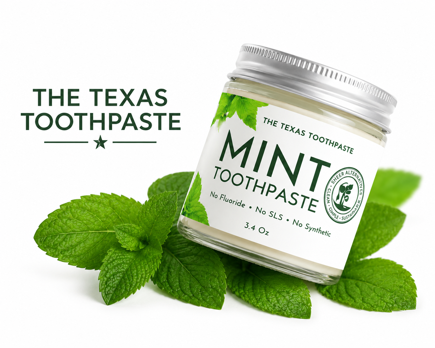 Jar of 'The Texas Toothpaste' mint toothpaste with mint leaves on a white background