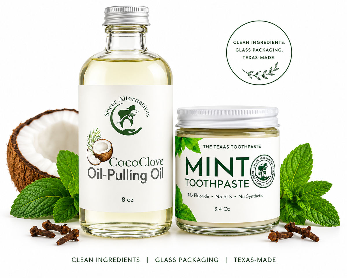 A glass bottle of CocoClove Oil-Pulling Oil and a glass jar of Mint Toothpaste from The Texas Toothpaste, styled with fresh mint leaves, cloves, and a halved coconut on a white background with promotional text.